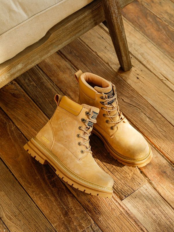 A pair of lightweight dumbbells neatly placed on a wooden floor.